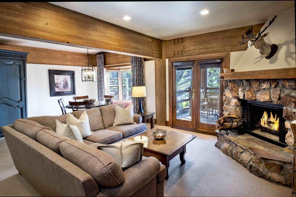 a living room with a couch and a fireplace at Luxury Three Bedroom Suite with Mountain Views and Three Hot Tubs apartment hotel in Park City
