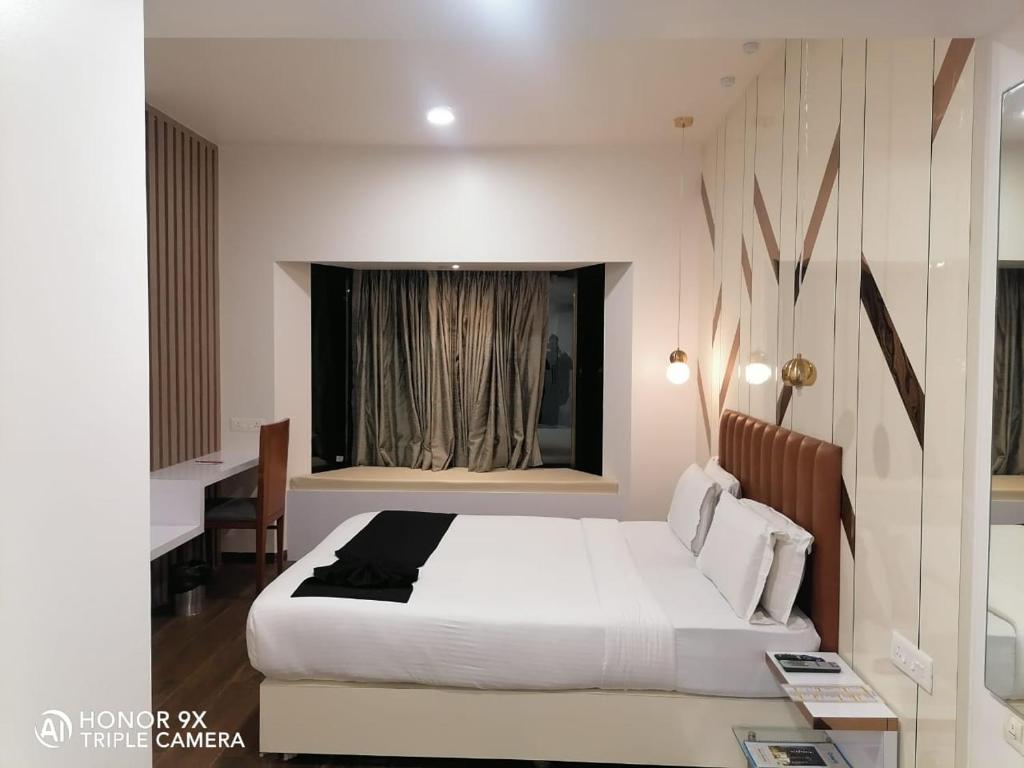 Postel nebo postele na pokoji v ubytování Orbett Hotel