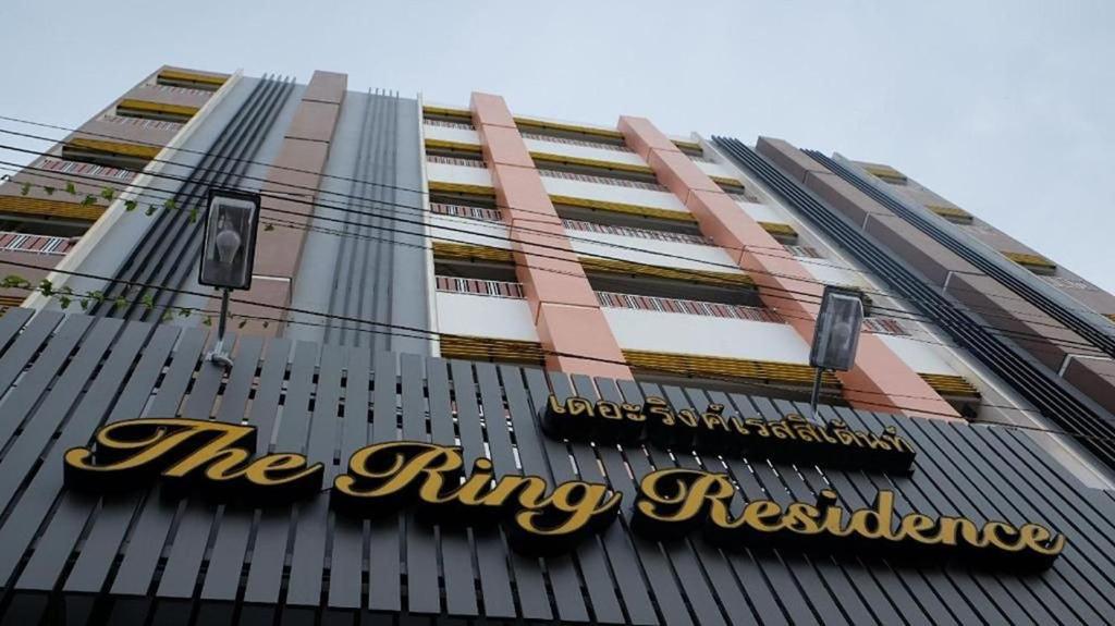 a tall building with a sign on the top of it at The Ring Residence in Hat Yai