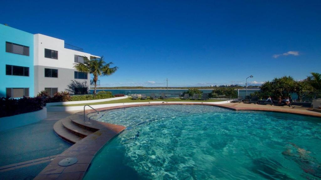 a large swimming pool in front of a building at Grand Pacific Unit 112 Caloundra QLD in Caloundra
