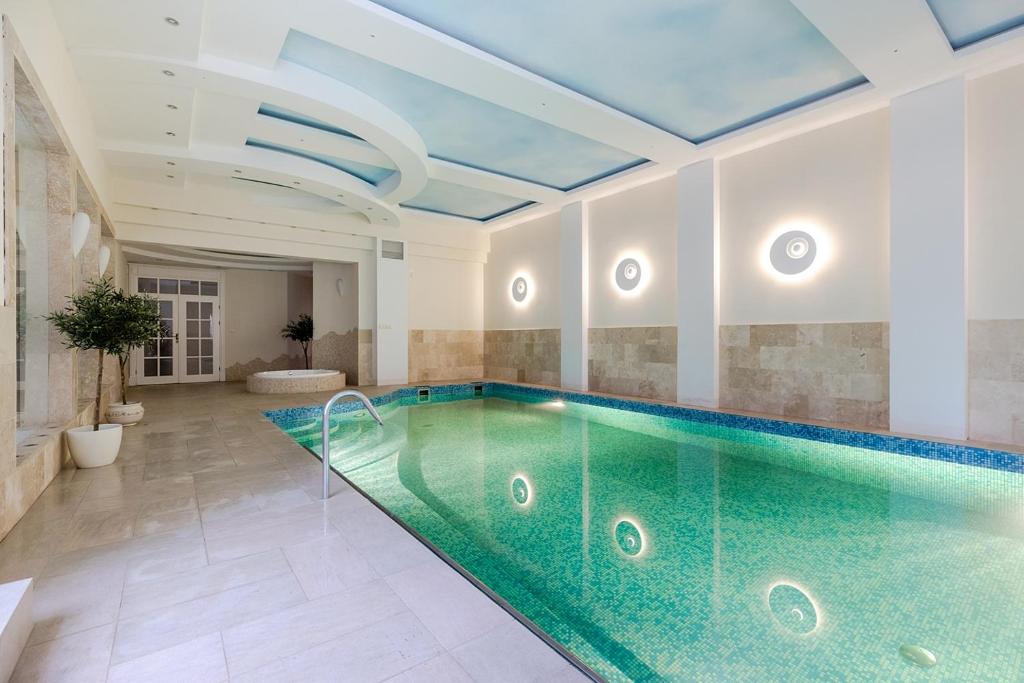 a swimming pool in a room with a ceiling at Luxury Villa Pool and Spa in Magdalenka