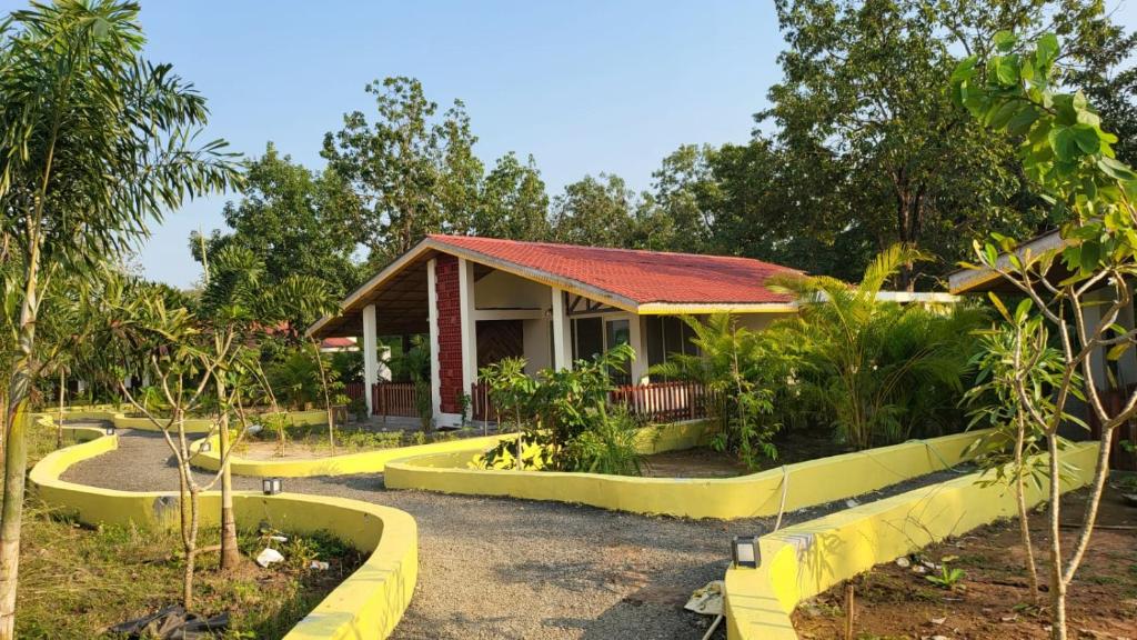 a house with a garden in front of it at THE INFINITY PENCH RESORT in Khawāsa