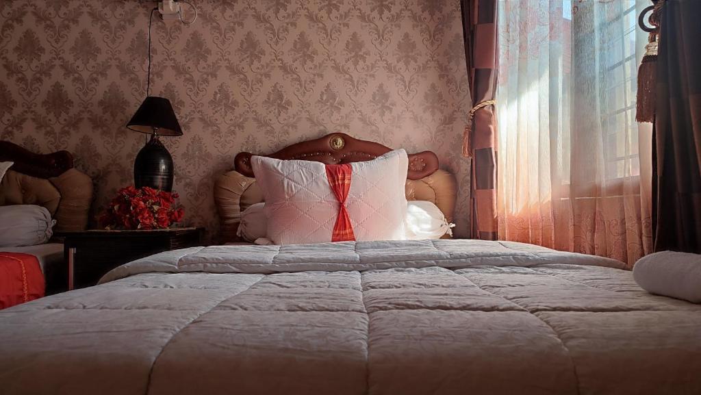 1 dormitorio con cama con almohada y ventana en Cendana Homestay, en Sawahlunto