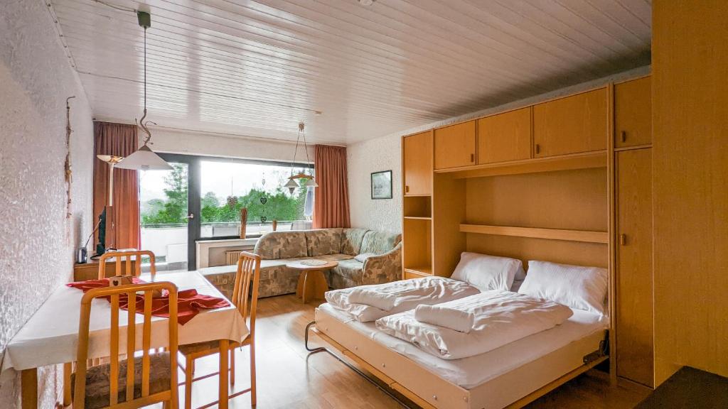 a bedroom with a bunk bed and a living room at Allgäu Appartementhaus Appartement ALLGÄU 02 in Pfronten