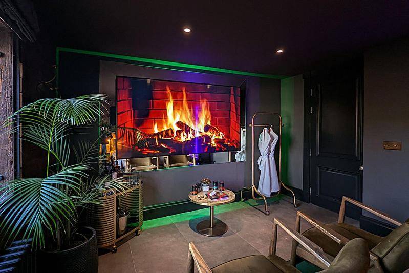 a living room with a fire in a fireplace at The Bells - Luxury Serviced Apartments in Leeds