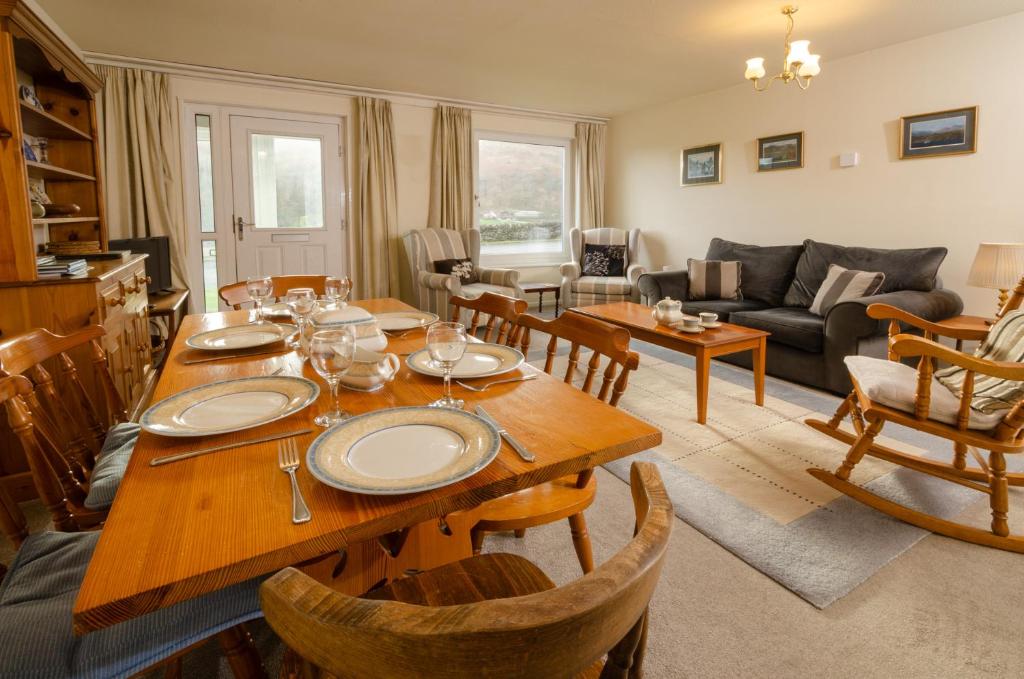 a living room with a wooden table and chairs at 18 Thrang Brow in Ambleside