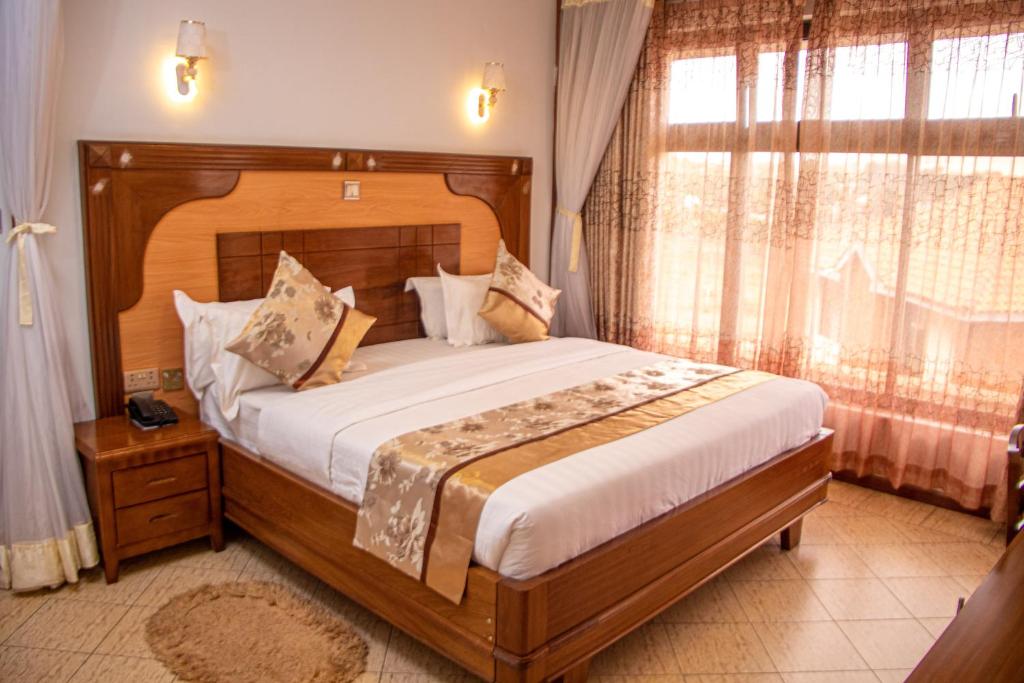 Postel nebo postele na pokoji v ubytování Grand Winston Hotel