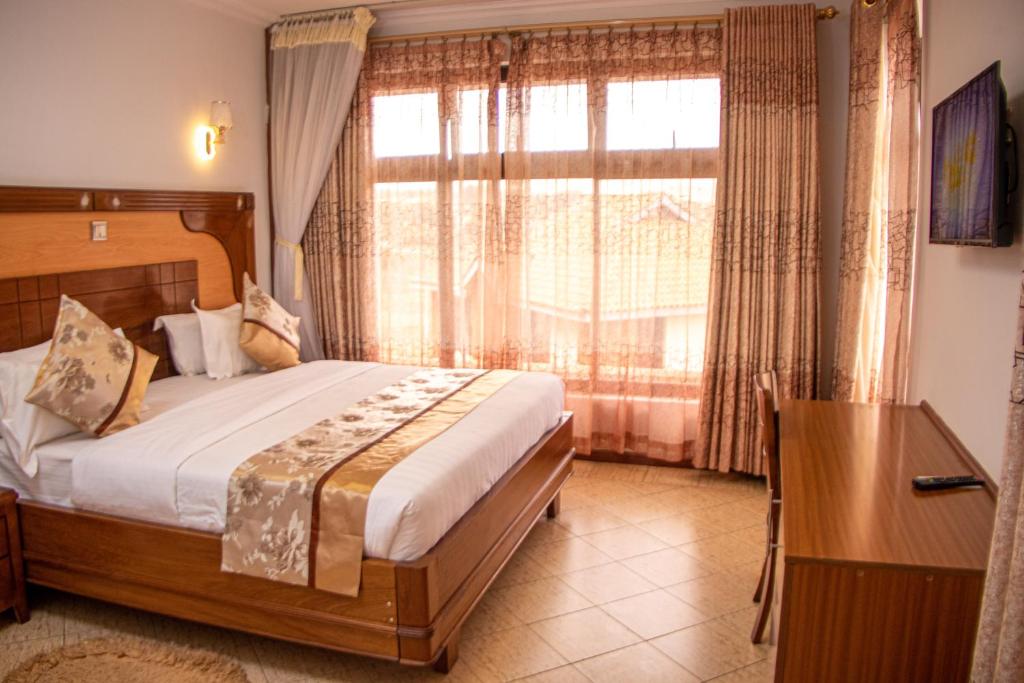 Postel nebo postele na pokoji v ubytování Grand Winston Hotel