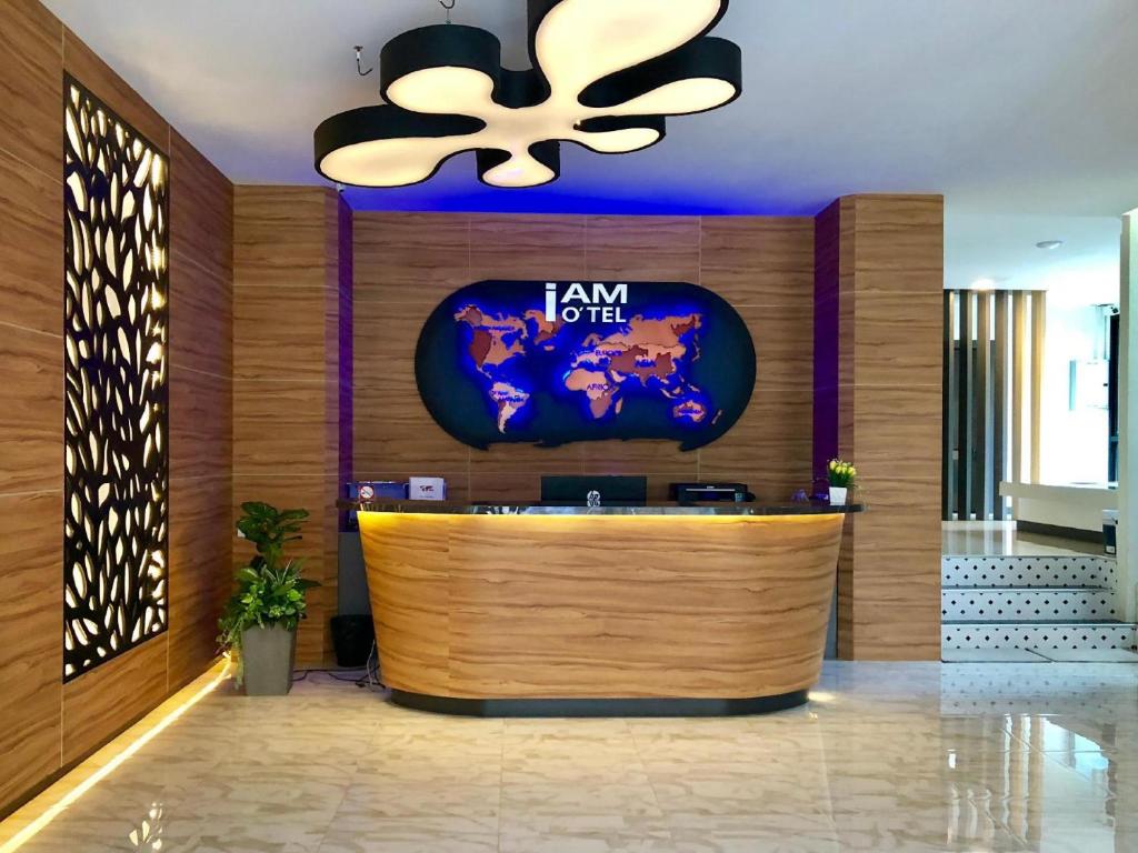 a lobby with a bar with a tv on the wall at I Am O'TEL PATONG Managed by Priew Wan Guesthouse in Patong Beach