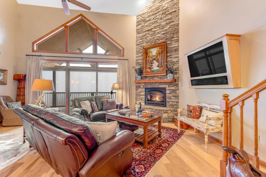 a living room with a couch and a fireplace at Reserve 14A in Sugar Mountain