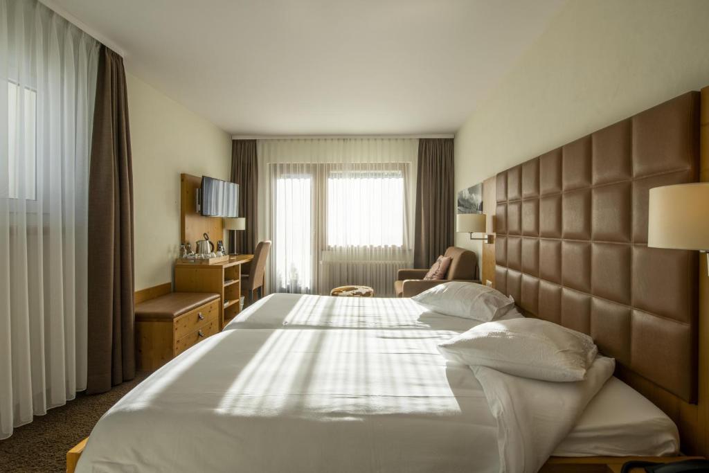 Postel nebo postele na pokoji v ubytování Hotel Olympic - Montana Center