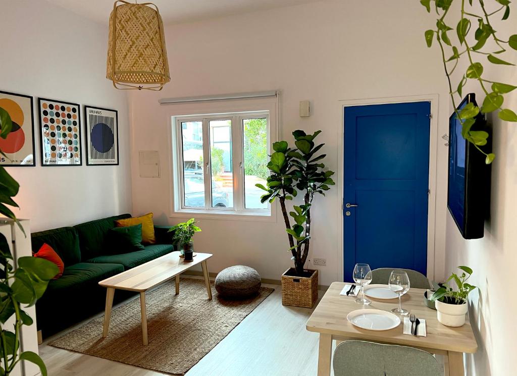 a living room with a green couch and a blue door at Central Ground Floor Apartment in Nicosia
