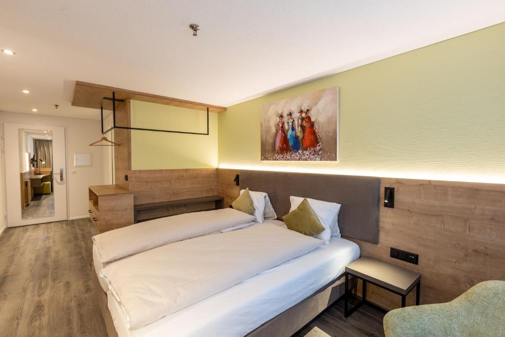 Postel nebo postele na pokoji v ubytování Hotel Flamatt