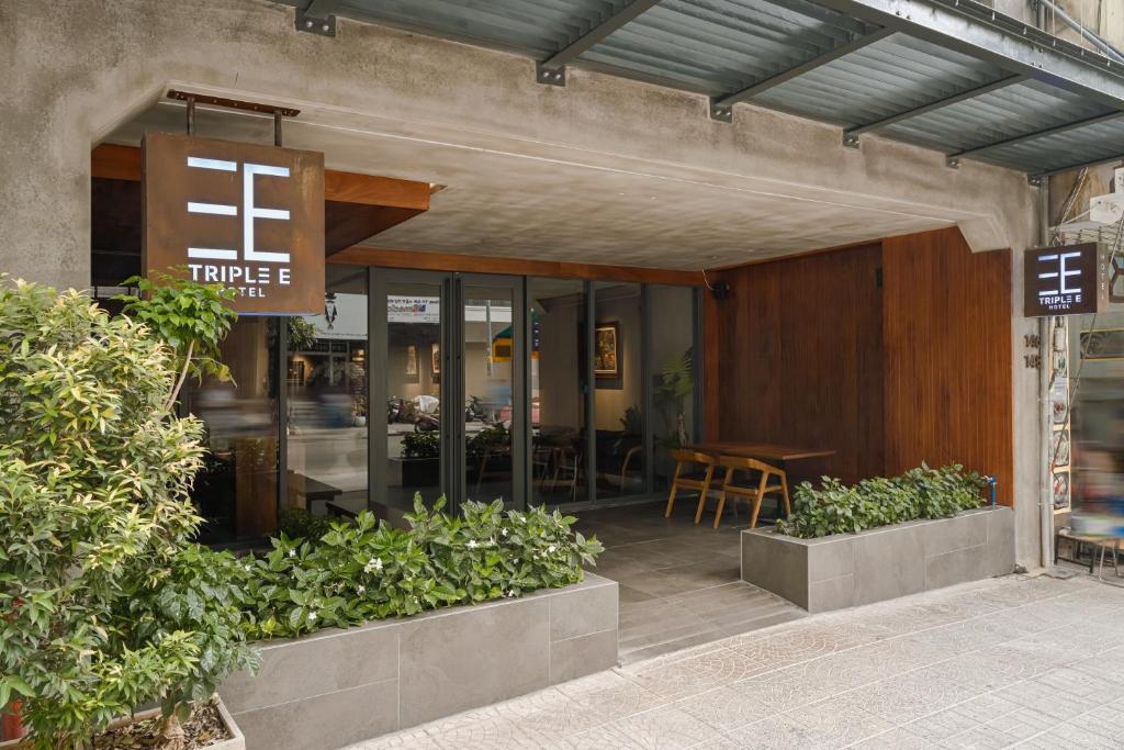 a entrance to a restaurant with a table and chairs at Triple E Hotel Metro Ben Thanh in Ho Chi Minh City