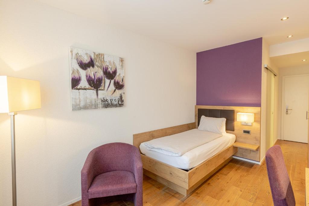 Postel nebo postele na pokoji v ubytování Hotel Flamatt