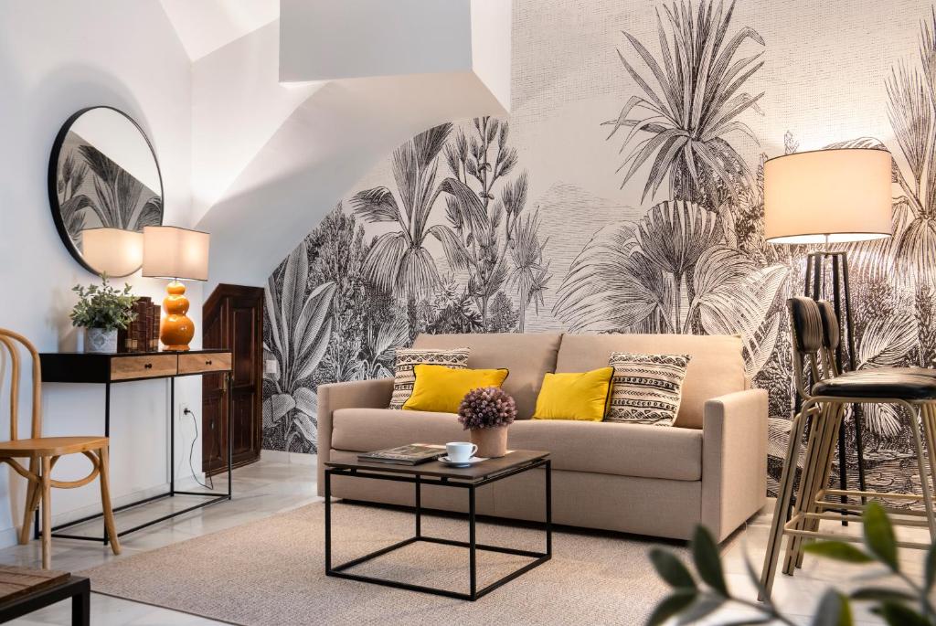 a living room with a couch and a table at Magno Apartments Hernando Colón in Seville