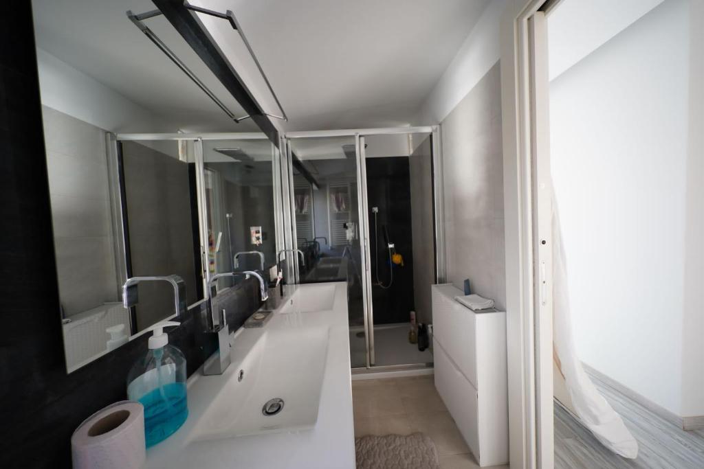 a bathroom with two sinks and a mirror at Eden Luxury Villa in Focene