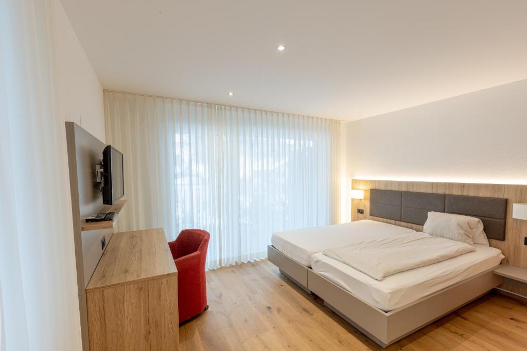Postel nebo postele na pokoji v ubytování Hotel Flamatt