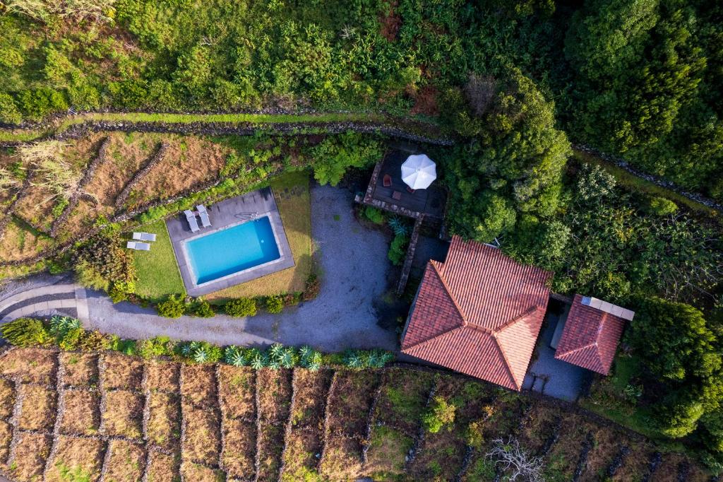 an aerial view of a house with a swimming pool at Stone Home Casa do Caisinho Pico island in Terra Alta