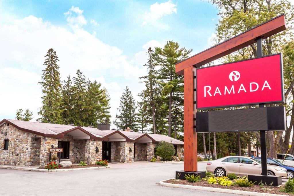 a sign for a rambala dealership in front of a building at Ramada by Wyndham Ottawa On The Rideau in Ottawa