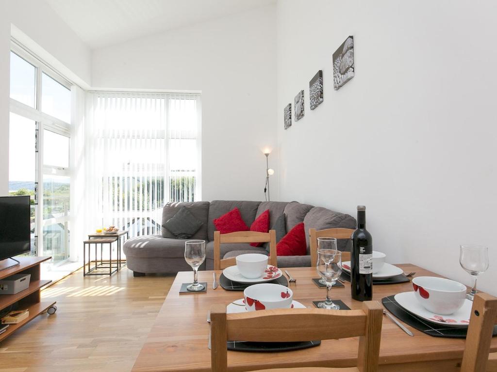 a living room with a couch and a table at Pass the Keys 2 Bed Sea View Apartment with Balcony Parking in Benllech