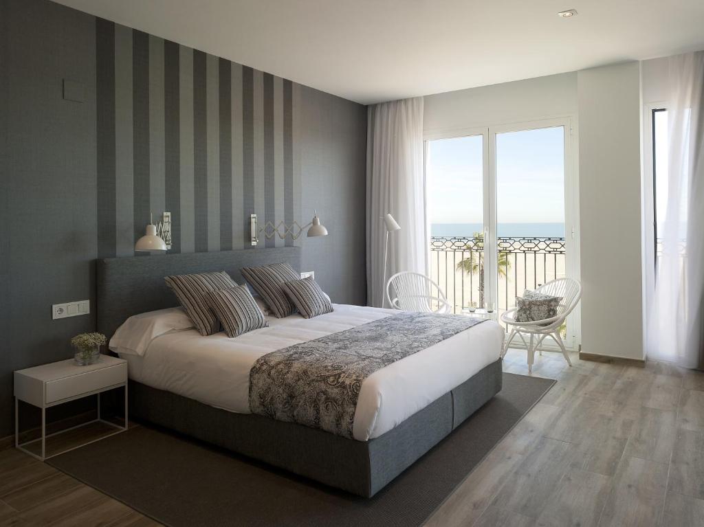 1 dormitorio con 1 cama grande y balcón en Hotel Boutique Balandret, en Valencia