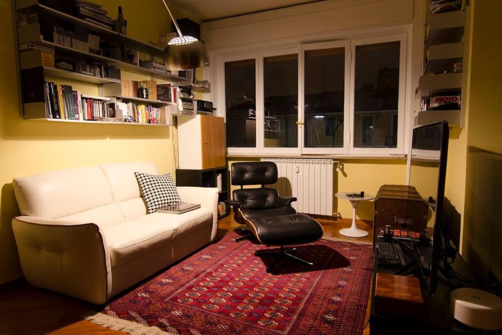 a living room with a white couch and a chair at Design apartment in the design district of Milan in Milan