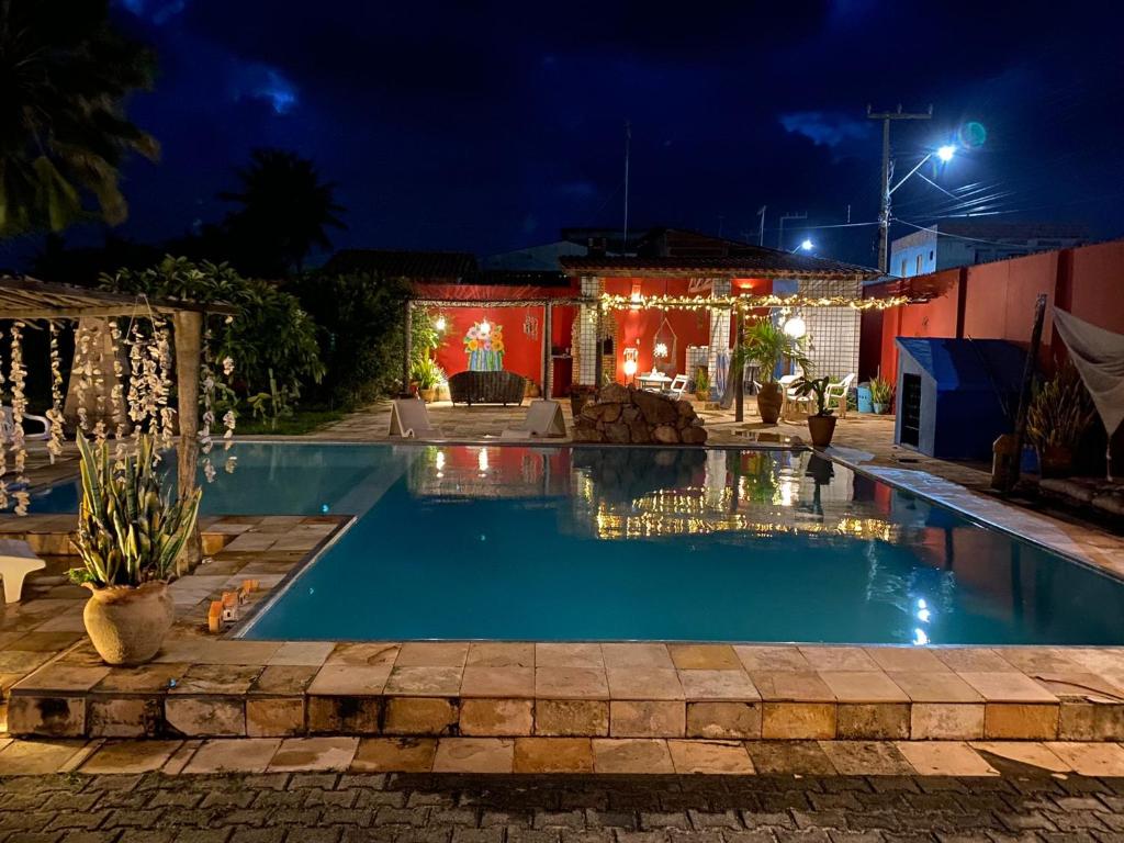 a swimming pool at night with christmas lights at Bed & Breakfast Casa de Valeria in Barra Nova