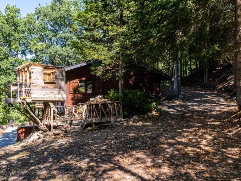 a log cabin in the woods next to a forest at Luxurious Chalet in the woods in Manhay