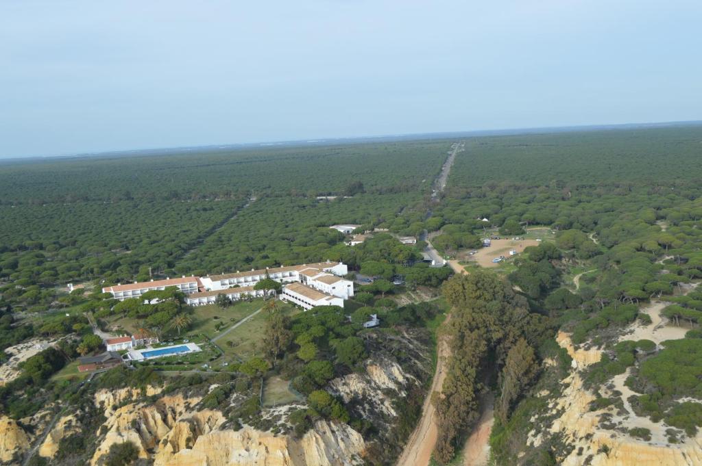 an aerial view of a building on the side of a mountain at Parador de Mazagón in Mazagón