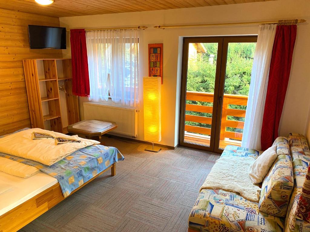A bed or beds in a room at Apartmány Limba