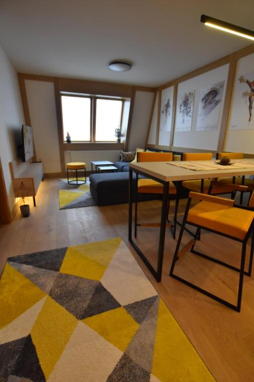 a living room with a table and a couch at Splendid View Place in Jahorina