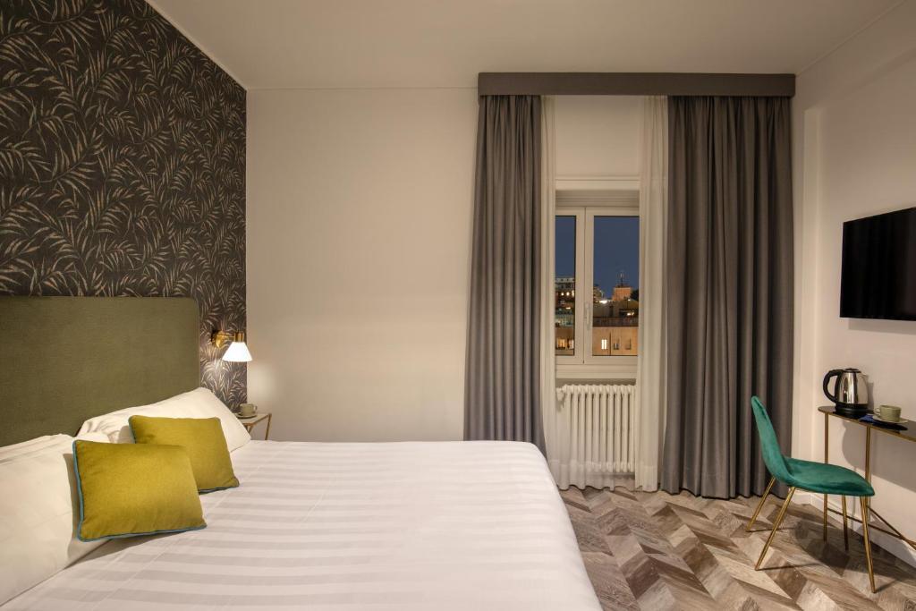 Postel nebo postele na pokoji v ubytování Bloom Hotel Rome