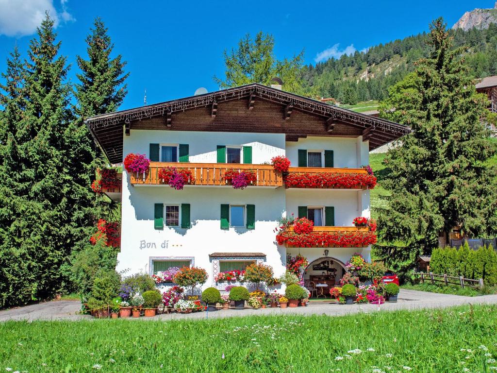 a building with flowers on the side of it at Garni Bondi in Selva di Val Gardena