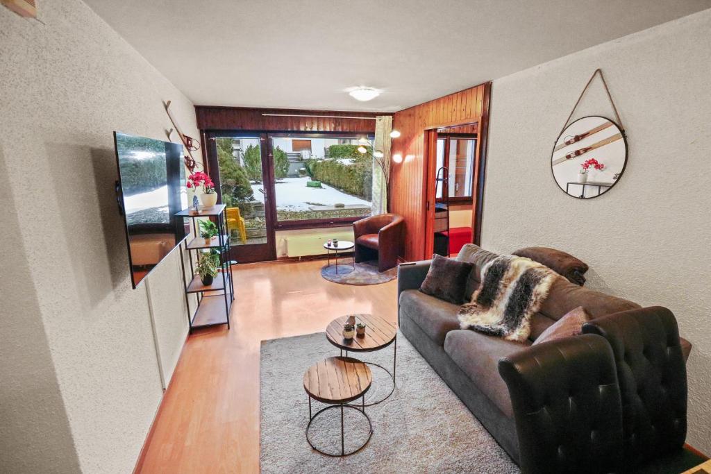 ein Wohnzimmer mit einem Sofa und einem Tisch in der Unterkunft Magnifique appartement centré in Crans-Montana