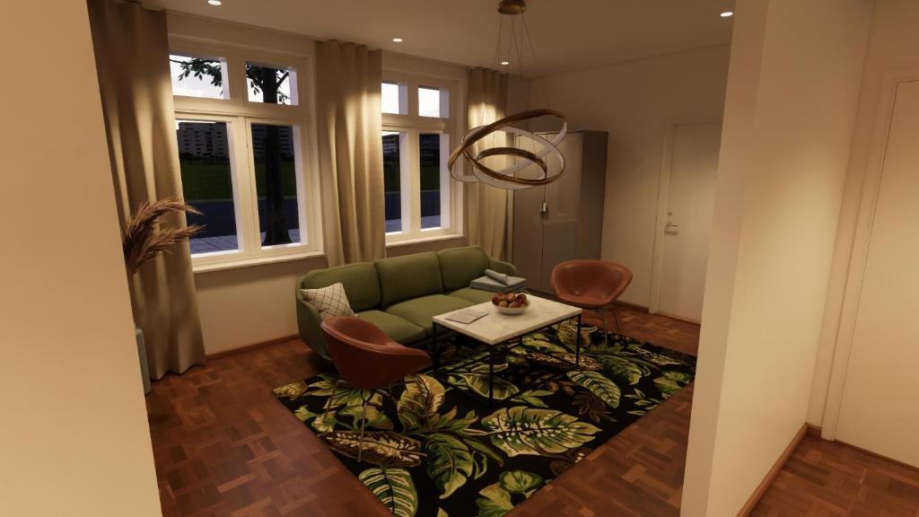 a living room with a green couch and a table at Esplanad Suites in Mariehamn