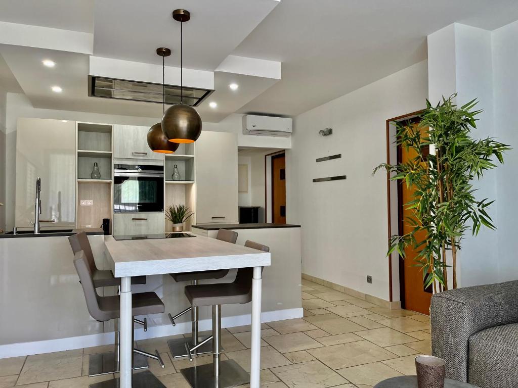 a kitchen and dining room with a table and chairs at Le Domaine Anse Marcel Beach Resort in Anse Marcel 