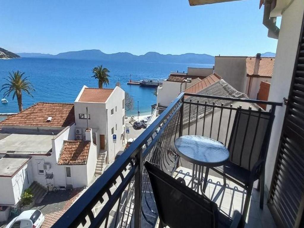 balcón con vistas al océano y a los edificios en Rooms Providenca, en Gradac