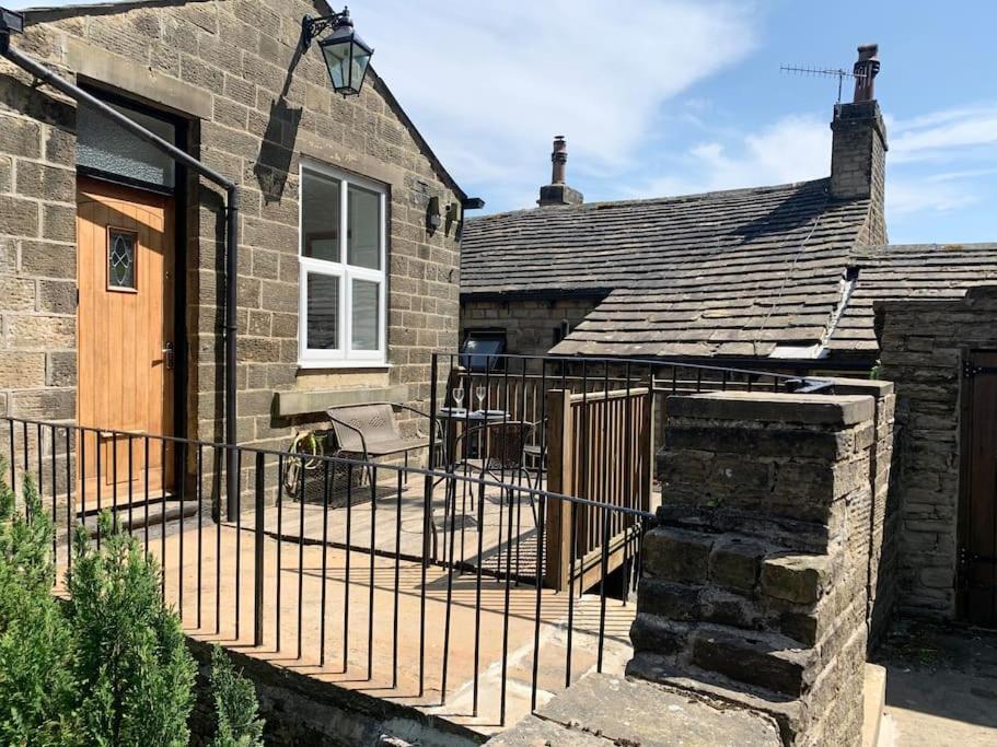 a house with a iron fence next to a building at Artist Hideaway Main Street Haworth in Haworth