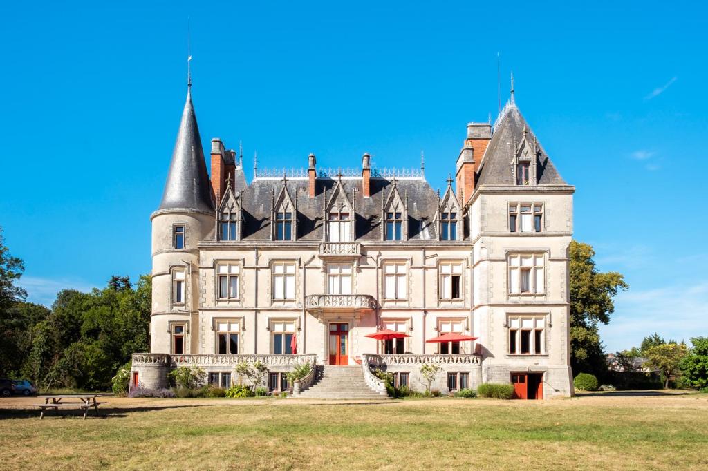 an old castle with a staircase in front of it at Château Le Boisrenault in Buzançais