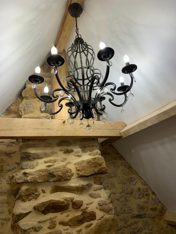 a chandelier hanging from the ceiling in a room at Gîte chez le Gaulois in Carsac-Aillac