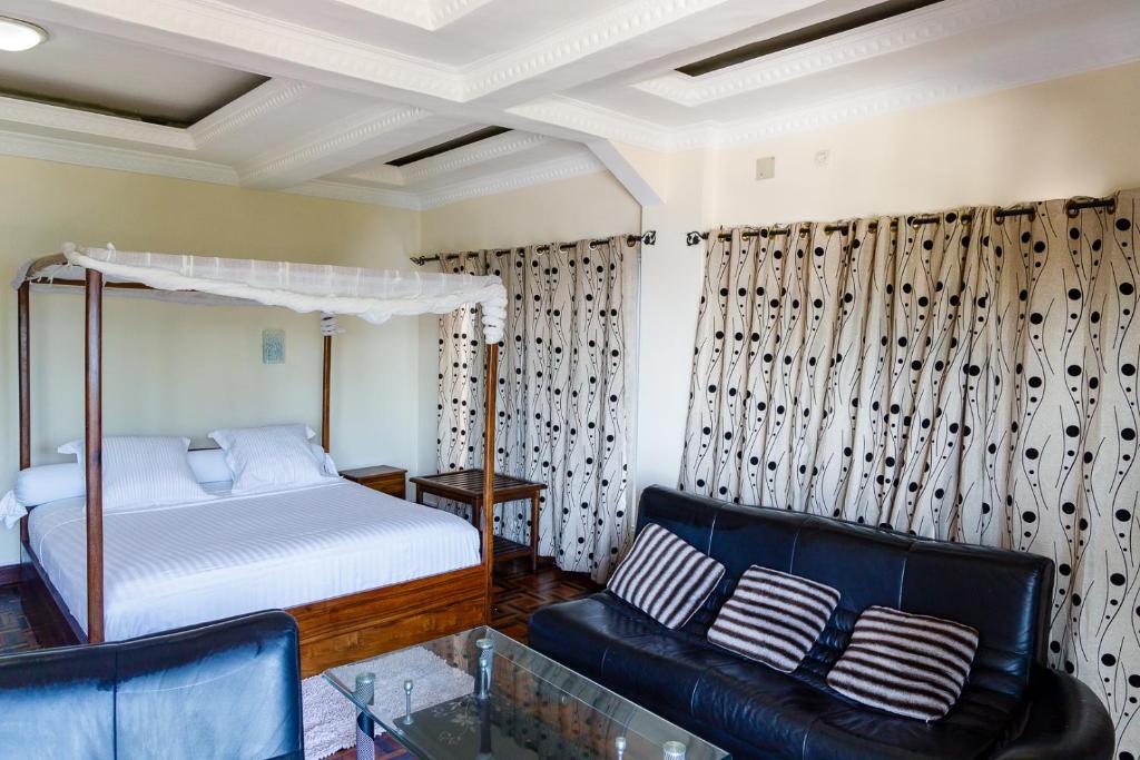 Postel nebo postele na pokoji v ubytování HOTEL MELROSE SAMBAVA