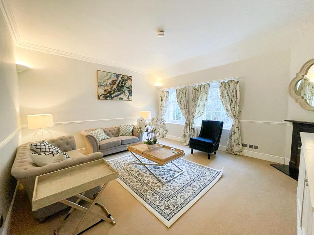 a living room with a couch and a table at Sophisticated 3BR with Garden, quiet New Town Lane in Edinburgh