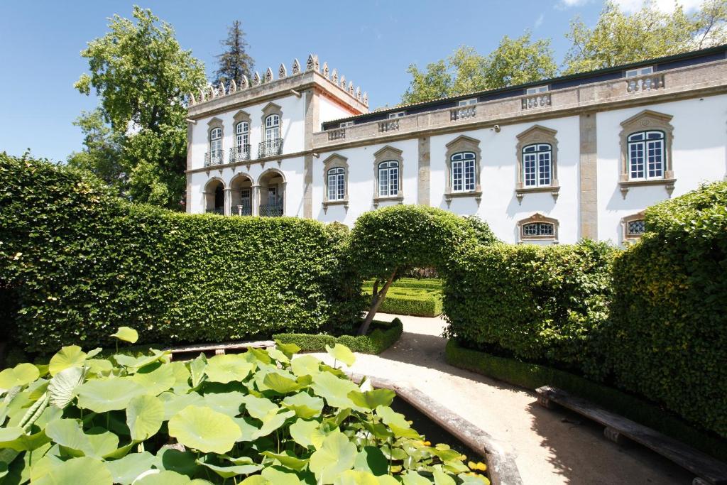 a house with a lotus pond in front of it at Parador Casa Da Insua in Penalva do Castelo