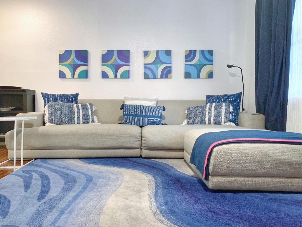 a living room with a couch and a blue rug at Pet-friendly Duplex, Big Shared Yard in Charming Historic Travis Heights! in Austin