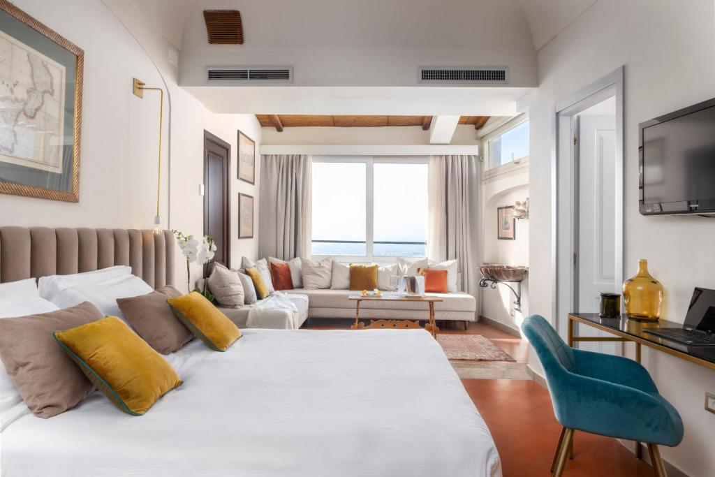 a bedroom with a bed and a living room at Hotel Villa Paradiso in Taormina