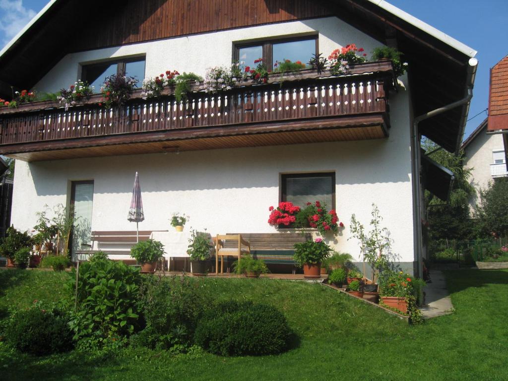 een huis met een balkon met bloemen erop bij Apartma Tilika in Kranjska Gora