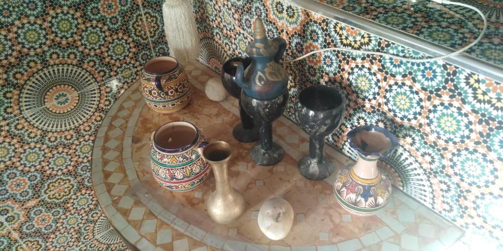 a group of vases sitting on a glass table at Fertassa mtls in Moulay Idriss