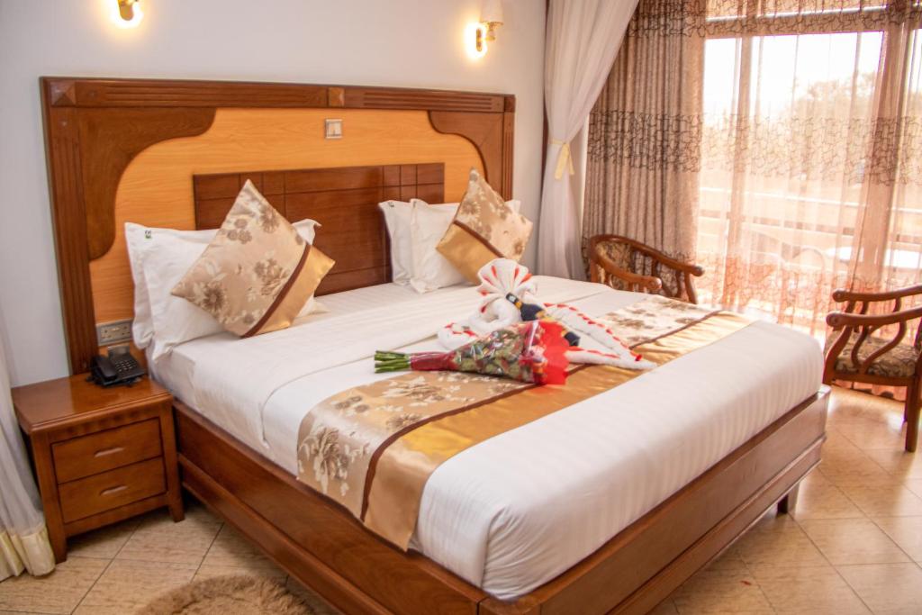 Postel nebo postele na pokoji v ubytování Grand Winston Hotel