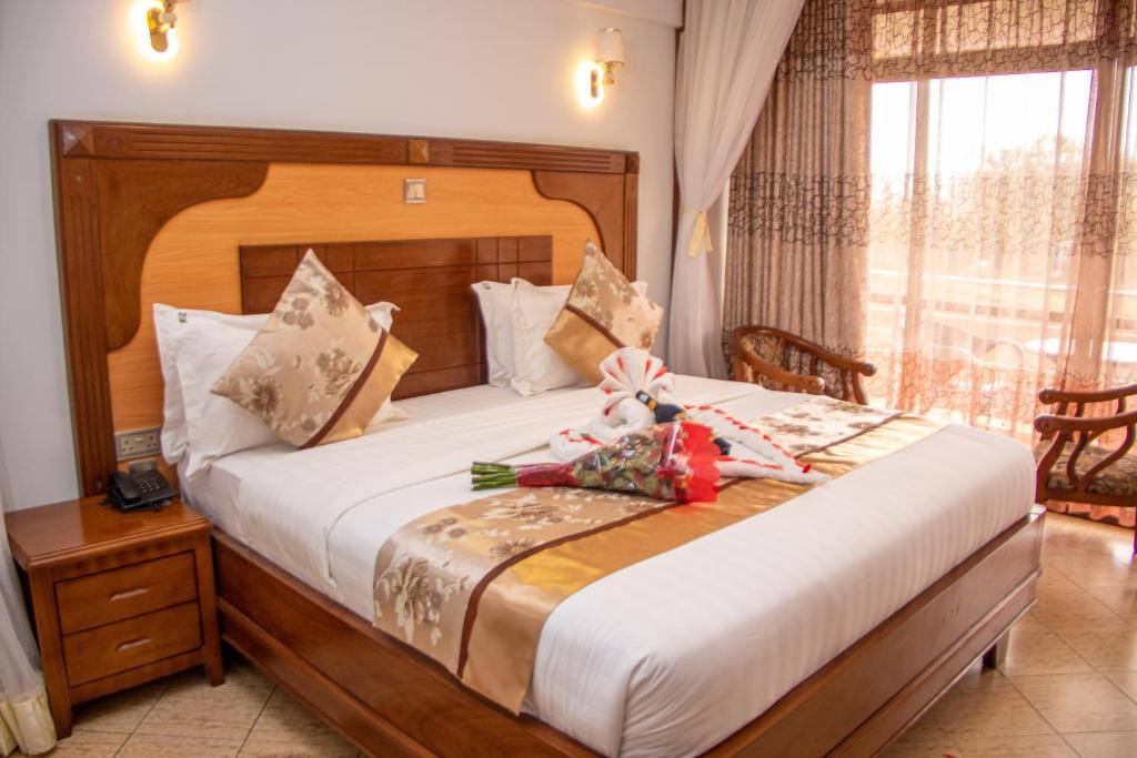 Postel nebo postele na pokoji v ubytování Grand Winston Hotel